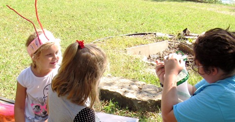 Hailey Moss, education specialist at the Schlagle Library, showed butterflies in a carrier to children attending the Lawson Roberts Butterfly Festival on Saturday at the Schlalge Library. (Staff photo by Mary Rupert)