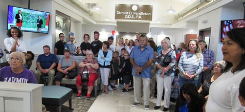 The group listened to speeches at the grand opening of the dental office today at 9000 State Ave. (Staff photo)