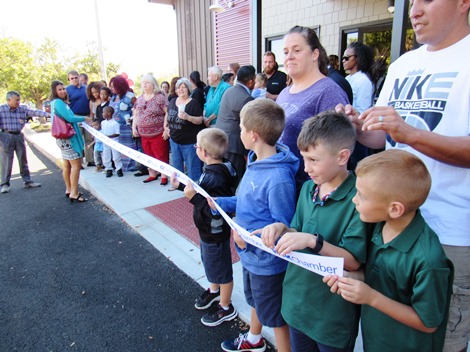 Holding the ribbon at the opening today of  Dr. Steven Pendleton's dental office at 9000 State Ave. (Staff photo)