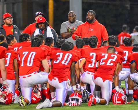 Coaches addressed the Wyandotte High School football team after the loss to Atchison High School in their game on Sept. 23. (Photo by Brian Turrel)