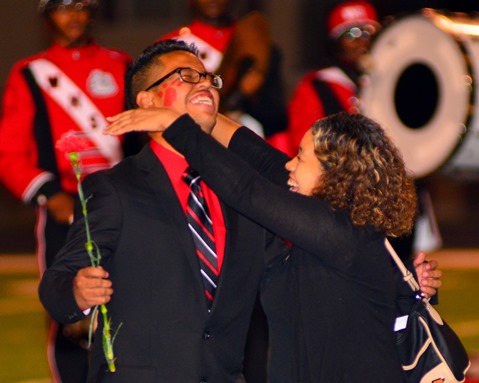 Alan Rosales received a hug from his mother as he was named Homecoming king for Wyandotte High School at halftime of the football game with Atchison High School on Sept. 23. (Photo by Brian Turrel)