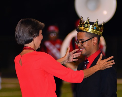 Mary Stewart, principal of Wyandotte High School, presented the Homecoming king's crown to Alan Rosales during halftime of the football game with Atchison High School on Sept. 23. (Photo by Brian Turrel)