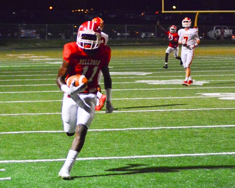 Wyandotte wide receiver GeRail Lucas (11) ran in a touchdown pass from quarterback Terrell Batts (12, background) during the second half of the football game between Wyandotte High School and Atchison High School on Sept. 23. (Photo by Brian Turrel) 