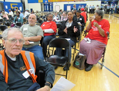 Dan Welch, left, a Kansas City, Kan., resident, chatted with residents before the start of the community forum on reducing violence. He said he was there to listen. The meeting was at Schlagle High School. (Staff photo by Mary Rupert)