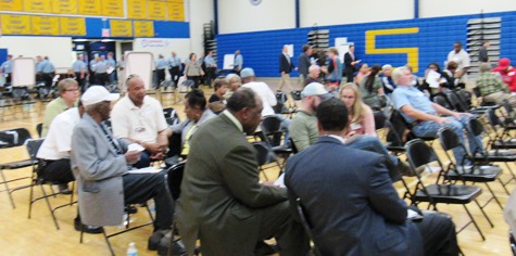 Before the start of the community forum tonight on reducing violence, people in the audience talked to each other. (Staff photo)