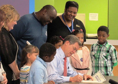 Gov. Sam Brownback signed a proclamation for Lights On Afterschool Day in Kansas on Thursday at the Boys and Girls Club in Kansas City, Kan. (Staff photo)