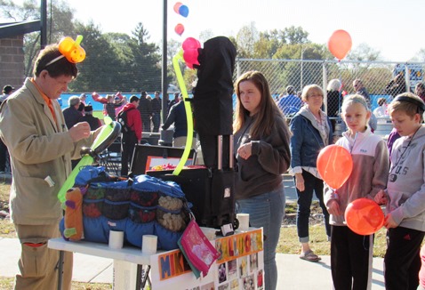 Many of those attending the KCKCC softball field ribbon-cutting today carried balloons. (Staff photo)