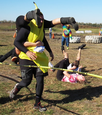 A couple from Omaha, Neb., right, took a tumble in the wife-carry event Saturday at Lakeside Speedway in Kansas City, Kan. The event was a benefit for the Reola Grant Center. (Staff photo)