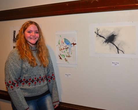 Bishop Ward student Natalie Wilson posed with some of her drawings at the Bishop Ward Art Show. (Photo by Brian Turrel)