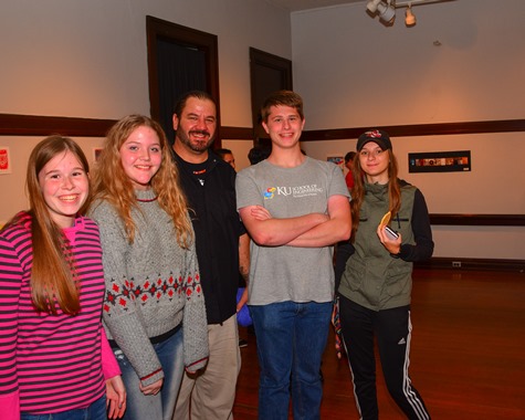 Bishop Ward High School art teacher Nick Tomasic, center, posed with current and former students at the Bishop Ward Art Show at the Alcott Arts Center on Oct. 8. (Photo by Brian Turrel)