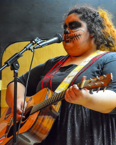 Bishop Ward student Regina Sanchez performed an original song during the Bishop Ward Art Show. (Photo by Brian Turrel)