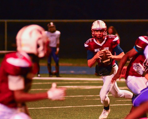 Washington quarterback Alex Howard looked for an open receiver on a pass play in the second quarter. (Photo by Brian Turrel)