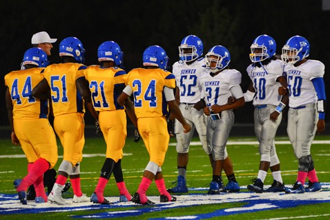 Captains for the Schlagle  High School and Sumner Academy football teams met at mid-field before the start of the game between their teams at Schlagle Stadium on Oct. 7.  Schlagle won the game 70-8. (Photo by Brian Turrel)