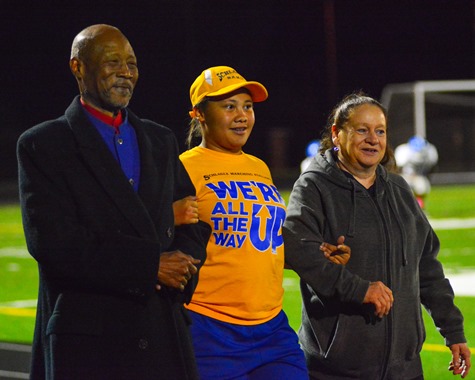 Schlagle Marching Band member Cornesha Hunter, middle, was recognized during the Senior Night ceremony. (Photo by Brian Turrel)