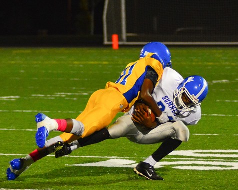 Schlagle freshman defensive back Kendall Brewer (81) put a hard hit on Sumner freshman wide receiver Xavier Wallace (24) following Wallace's reception in the fourth quarter. (Photo by Brian Turrel)