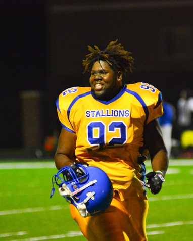 Schlagle junior lineman Cecil Barnett (92) sprinted off the field with a smile following his team's victory over Sumner. (Photo by Brian Turrel)