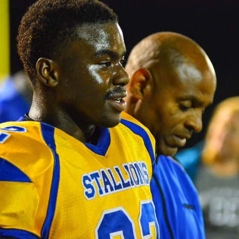 Neil Ruff, accompanied by Schlagle head coach Dwayne Williams, was honored on Schlagle Senior Night, along with members of the football team, auxiliary, and marching band.  The ceremony took place at halftime of the game between Sumner and Schlagle high schools on Oct. 7. (Photo by Brian Turrel)