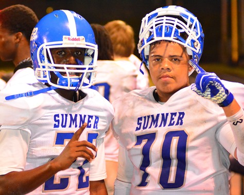 Sumner freshman wide receiver Jerry Ross (22) and sophomore offensive lineman Juan Owens (70) relaxed on the sidelines while the team's defense was on the field. (Photo by Brian Turrel)