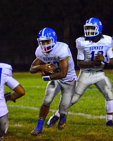 Sumner senior running back Kylen Lindesay took a handoff from sophomore quarterback Nahshon Houston during the fourth quarter of the team's game against Bishop Ward on Sept. 30. (Photo by Brian Turrel)