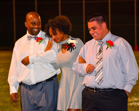 Bishop Ward senior Kiandra Hobley wiped away a tear as she was announced as Bishop Ward homecoming queen at halftime of the football game against Sumner on Sept. 30.  She was attended by her father and Bishop Ward senior Michael Ledesma. (Photo by Brian Turrel)