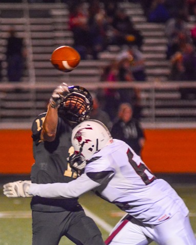 Washington defensive lineman Adam Parker (65) hit Jaelon Harley as he threw.  The defensive pressure led to an interception that was run back for a touchdown by Washington. (Photo by Brian Turrel)