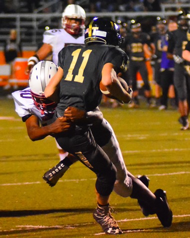 Washington junior defensive lineman Donshea Edwards (40) made a tackle on Jaelon Harley in the third quarter. (Photo by Brian Turrel)