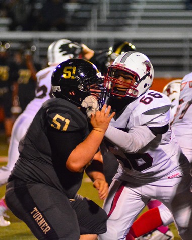 Turner junior lineman Rodney Carroll (51) and Washington sophomore lineman Adarius Barber (66) engaged at the line of scrimmage. (Photo by Brian Turrel)