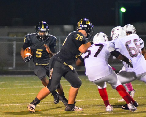 Ryan Johnson made a block on Washington senior linebacker Jordan Goodwin (57) to spring Jaylin Richardson for a first down run during the fourth quarter. (Photo by Brian Turrel)