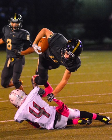 Jaelon Harley was upended by Keyshawn King on a quarterback run. (Photo by Brian Turrel)