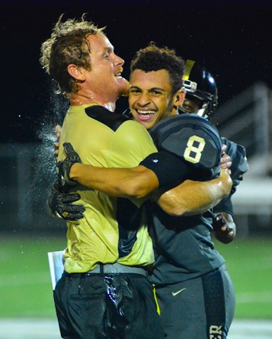 Following the game, Turner head coach Jeremy Milne received a congratulatory hug from Jordan Martin immediately after Milne was doused with ice water by his players. (Photo by Brian Turrel)