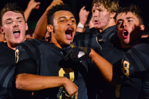 The Turner football team chanted in celebration after its victory over Washington High School in the Class 5A playoff game between the two schools on Oct. 28. (Photo by Brian Turrel)