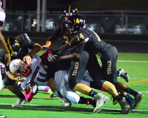 Washington junior wide receiver Keyshawn King (4) was tackled by multiple Turner defenders on a kickoff return. (Photo by Brian Turrel)