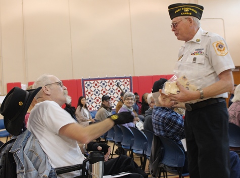 Pins were handed out during the Wyandotte County Veterans Day Commemoration program on Saturday, Nov. 5, at the Salvation Army Harbor Light Village, 6723 State Ave. (Photo by Steve Rupert)