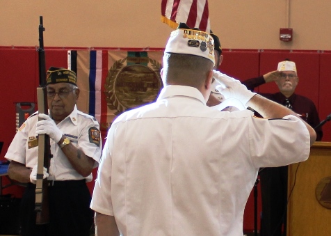 Saluting the flag during the presentation of the colors at the Wyandotte County Veterans Day Commemoration program on Saturday, Nov. 5, at the Salvation Army Harbor Light Village, 6723 State Ave., Kansas City, Kan. (Photo by Steve Rupert)