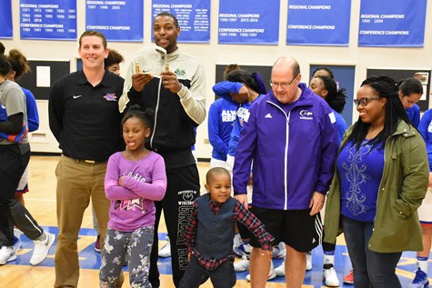 New KCKCC Athletic Hall of Famer Dennis Tinnon displayed his Hall of Fame plaque along with admirers, from left, KCK Athletic Director Tony Tompkins, daughter Denyah, son Dennis III, former KCKCC assistant coach Bill Sloan and wife, Robin. (KCKCC photo by Alan Hoskins)