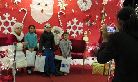 Children visited Santa and Mrs. Claus while parents took photos at the holiday lighting ceremony Friday night at Kansas City, Kan., City Hall. (Photo by Mary Rupert)