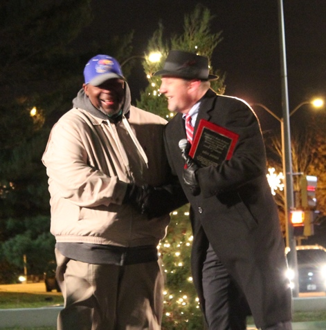 Don Jones, left, Unified Government director of buildings, received a plaque Friday night from Mayor Mark Holland recognizing his work on the Mayor's Downtown Holiday Lighting Ceremony. (Photo by Steve Rupert)