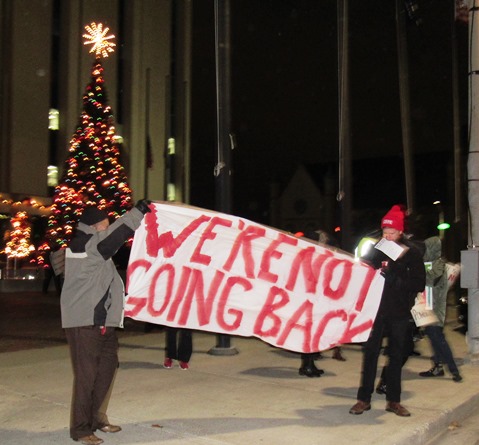 A small group of people held a rally about 6 p.m. Dec. 15 outside City Hall. “We’re not going back,” said one of the signs that they were holding. Several issues were mentioned, including immigration. The Wyandotte Rally for Solidarity stated all people deserved to be free from fear so that together they could build the world they want. (Staff photo by Mary Rupert) 