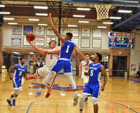 Kellen Turner, whose dramatic 3-point goal nearly forced a second overtime, didn’t get a basket with this acrobatic move  but it did give the KCKCC guard two crucial free throws in the Blue Devils’ 80-78 loss to Iowa Western Tuesday. (KCKCC photo by Alan Hoskins) 