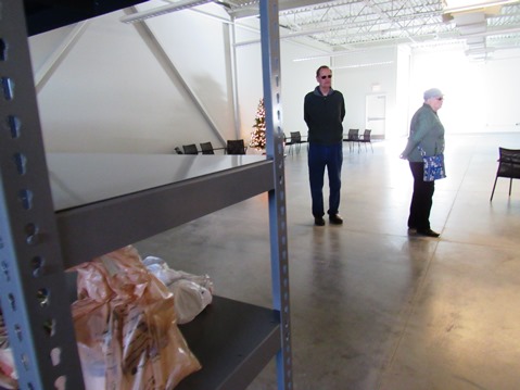 A few people dropped off sacks of groceries and placed them on the empty shelves at the new Cross-Lines building, which will include a food pantry. (Staff photo by Mary Rupert)