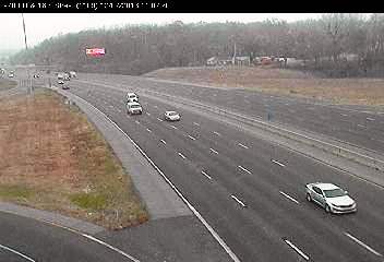 Snow is falling on area highways, including I-70 at 18th Street. Snow began falling in Kansas City, Kan., and Wyandotte County, shortly before 11 a.m. Wednesday. It is the first real snowfall of the winter here. Temperatures are currently 28 degrees in Kansas City, Kan., with a high expected of 31 today. Little or no snow is expected to accumulate, between a light dusting and a half inch, the weather service predicted. (KC Scout photo) 