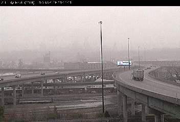 Snow is falling on area highways, including I-70 at I-670. Snow began falling in Kansas City, Kan., and Wyandotte County, shortly before 11 a.m. Wednesday. It is the first real snowfall of the winter here. Temperatures are currently 28 degrees in Kansas City, Kan., with a high expected of 31 today. Little or no snow is expected to accumulate, between a light dusting and a half inch, the weather service predicted. (KC Scout photo) 