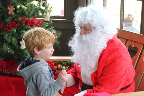 What do I want for Christmas? Let me think ... Children met with Santa Claus on Saturday at the National Agricultural Center and Hall of Fame, Bonner Springs, to talk about their Christmas wishes. More visits with Santa Claus are scheduled from 10 a.m. to 2 p.m. Sunday, Dec. 4, Saturday, Dec. 10, and Sunday, Dec. 11, at the Ag Hall, 126th and State Avenue, Bonner Springs. For more information, visit http://www.aghalloffame.com. (Photo by Steve Rupert)