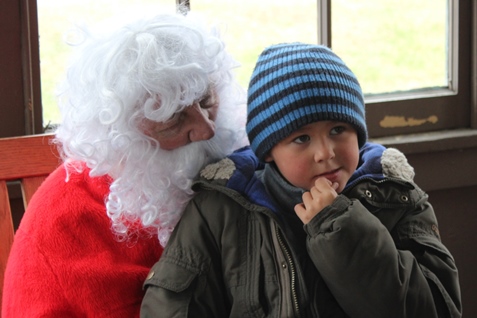 What do I want for Christmas? Let me think ... Children met with Santa Claus on Saturday at the National Agricultural Center and Hall of Fame, Bonner Springs, to talk about their Christmas wishes. More visits with Santa Claus are scheduled from 10 a.m. to 2 p.m. Sunday, Dec. 4, Saturday, Dec. 10, and Sunday, Dec. 11, at the Ag Hall, 126th and State Avenue, Bonner Springs. For more information, visit http://www.aghalloffame.com. (Photo by Steve Rupert)