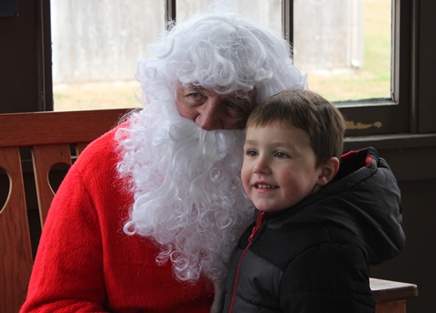 What do I want for Christmas? Let me think ... Children met with Santa Claus on Saturday at the National Agricultural Center and Hall of Fame, Bonner Springs, to talk about their Christmas wishes. More visits with Santa Claus are scheduled from 10 a.m. to 2 p.m. Sunday, Dec. 4, Saturday, Dec. 10, and Sunday, Dec. 11, at the Ag Hall, 126th and State Avenue, Bonner Springs. For more information, visit http://www.aghalloffame.com. (Photo by Steve Rupert)