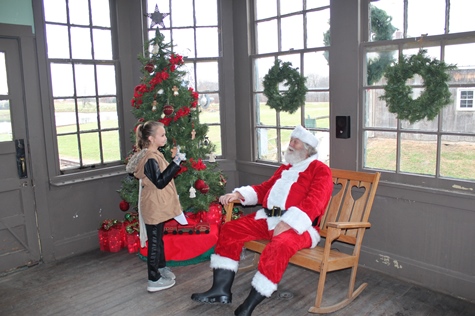 What do I want for Christmas? Let me think ... Children met with Santa Claus on Saturday at the National Agricultural Center and Hall of Fame, Bonner Springs, to talk about their Christmas wishes. More visits with Santa Claus are scheduled from 10 a.m. to 2 p.m. Sunday, Dec. 4, Saturday, Dec. 10, and Sunday, Dec. 11, at the Ag Hall, 126th and State Avenue, Bonner Springs. For more information, visit http://www.aghalloffame.com. (Photo by Steve Rupert)