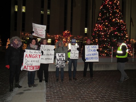 A small group of people held a protest about 6 p.m. Dec. 15 outside City Hall. “We’re not going back,” said one of the signs that they were holding. Several issues were mentioned, including immigration. The Wyandotte Rally for Solidarity stated all people deserved to be free from fear so that together they could build the world they want. (Staff photo by Mary Rupert) 