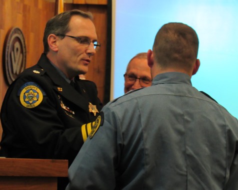 Jeffrey Fewell, administrator of the Wyandotte County Jail, with new graduates at a ceremony Dec. 15 at Kansas City, Kan., City Hall. (Staff photo by Mary Rupert) 