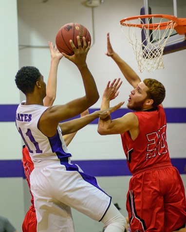 Piper High School senior Jalen Taylor (11) took a shot over Ottawa High School senior Perry Carroll (30) during the first quarter of the boys' basketball game between the teams, played on Dec. 2 at Piper.  Piper lost the game 87 to 77. (Photo by Brian Turrel)	