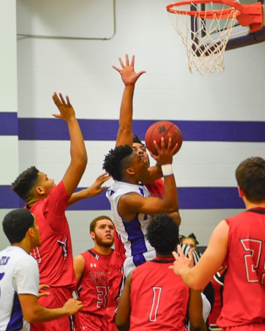 Piper junior Daviance Covington (1) rose up through a cluster of Ottawa defenders for a shot in the second quarter. (Photo by Brian Turrel)